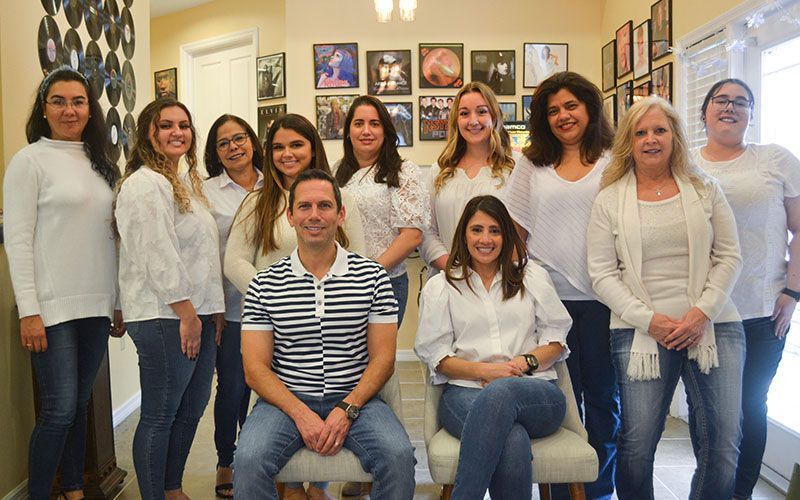 A group of people are posing for a picture in a room.