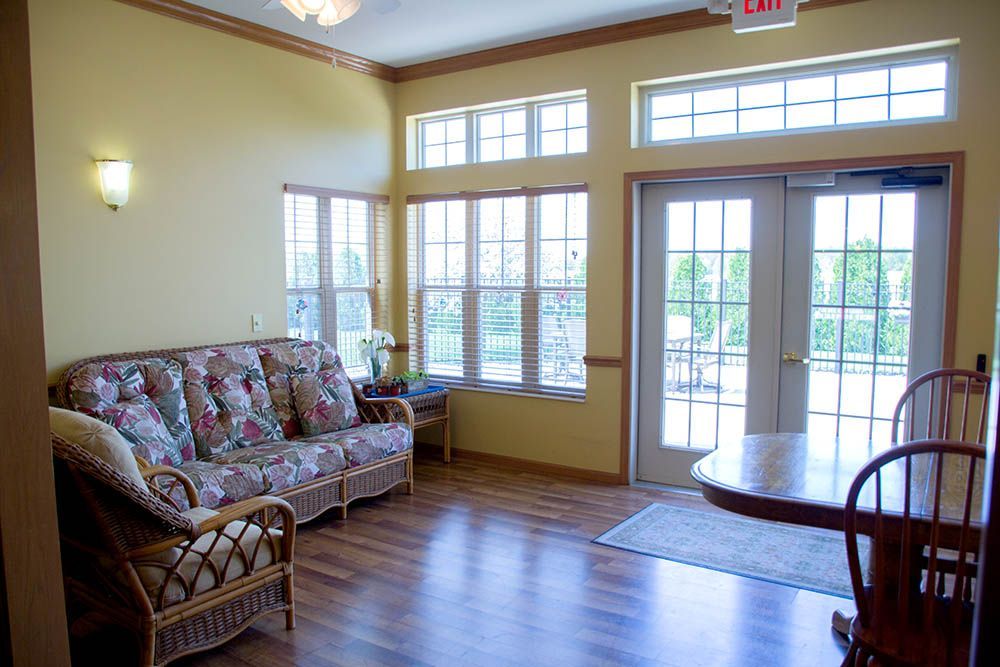 A living room with a couch , table and chairs.