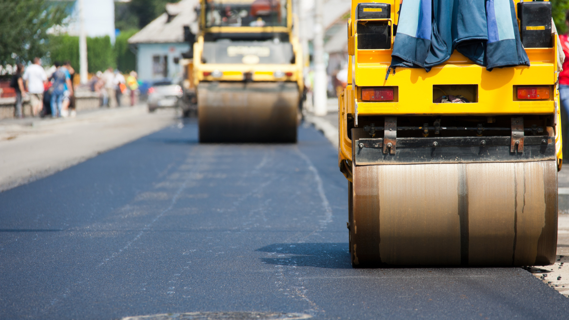 Two asphalt rollers are working on a road.