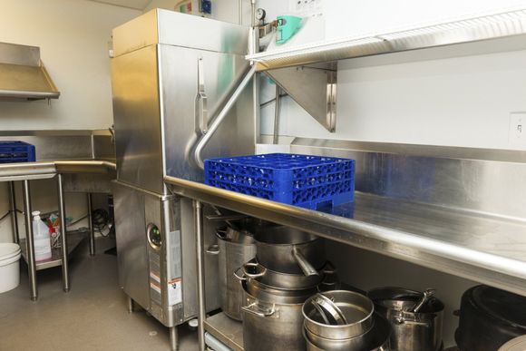 The view of a commercial kitchen behind a service counter.