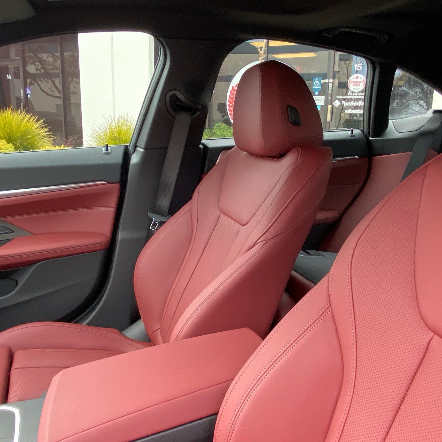 The inside of a car with red leather seats