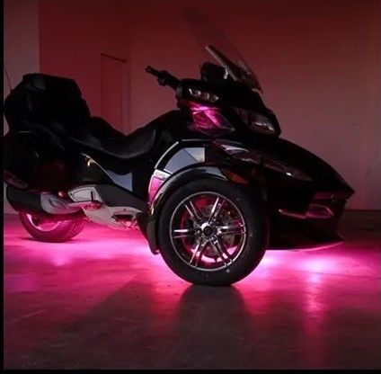 A boat is floating on top of a body of water at sunset.