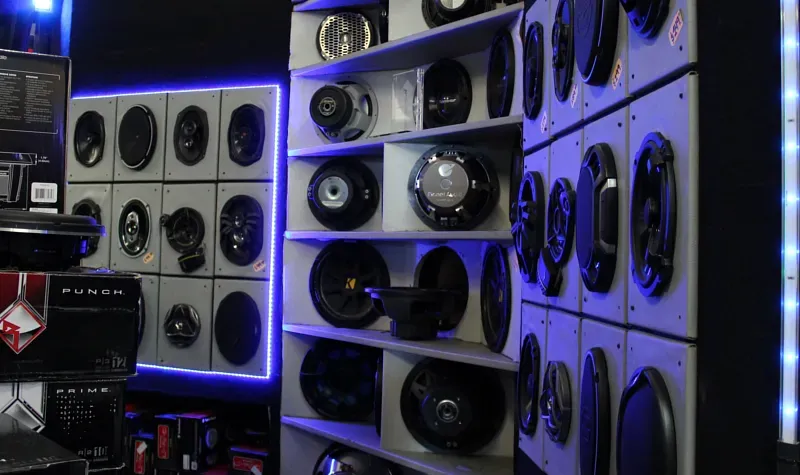 A room filled with lots of speakers on shelves.