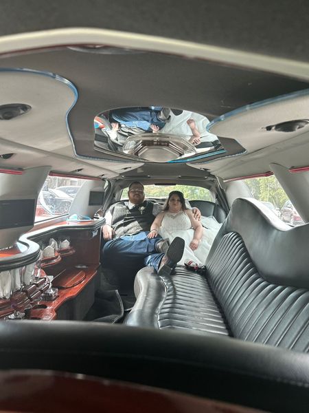 Interior of a decorated limousine with two passengers seated in the back