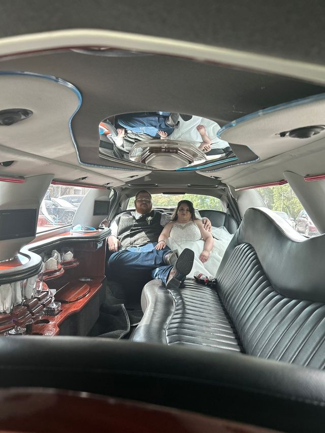 Interior of a decorated limousine with two passengers seated in the back