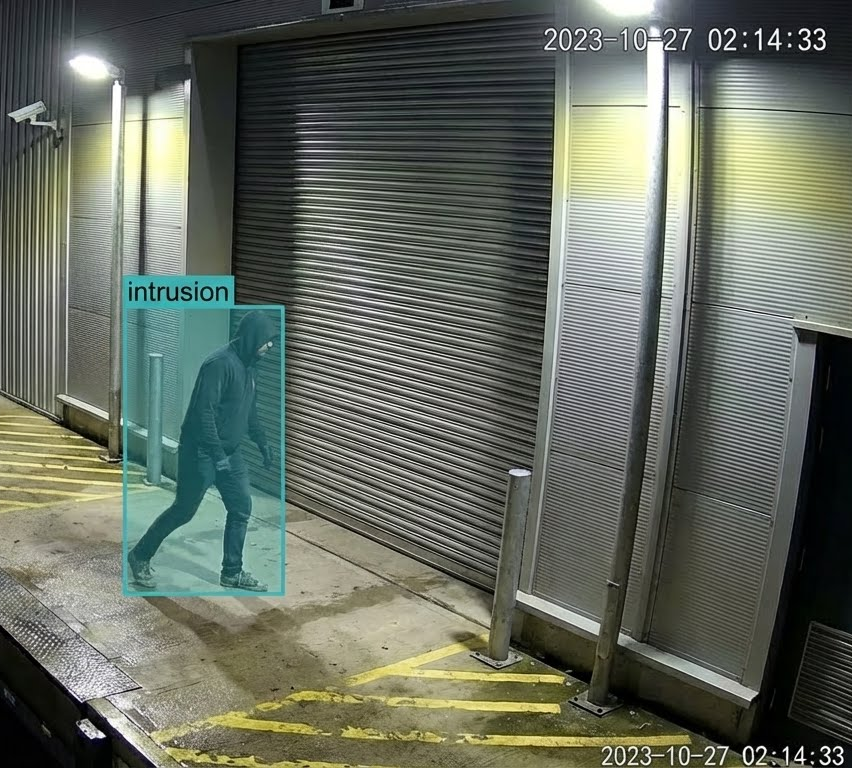 A man walks through a warehouse with the number 217 on the wall