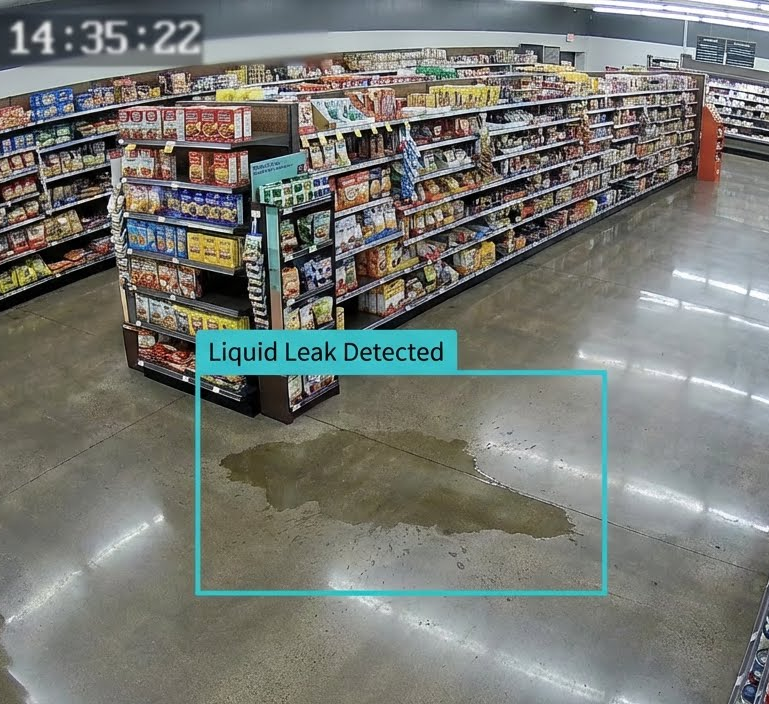 A man in a yellow vest stands in front of a waterfall
