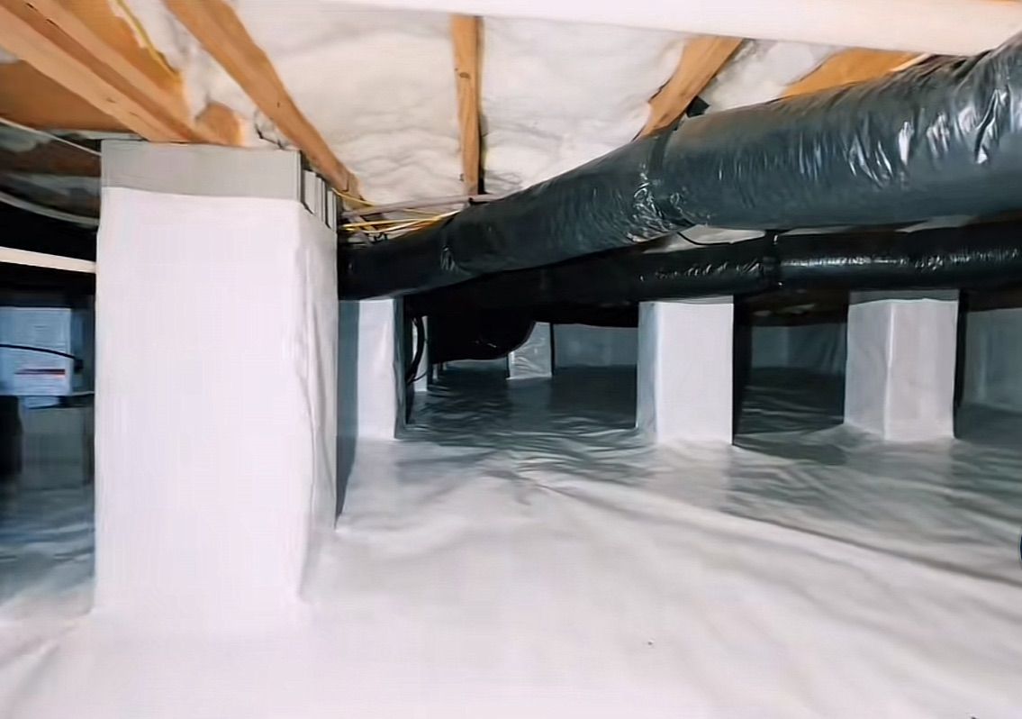 A basement with a lot of pipes coming out of it