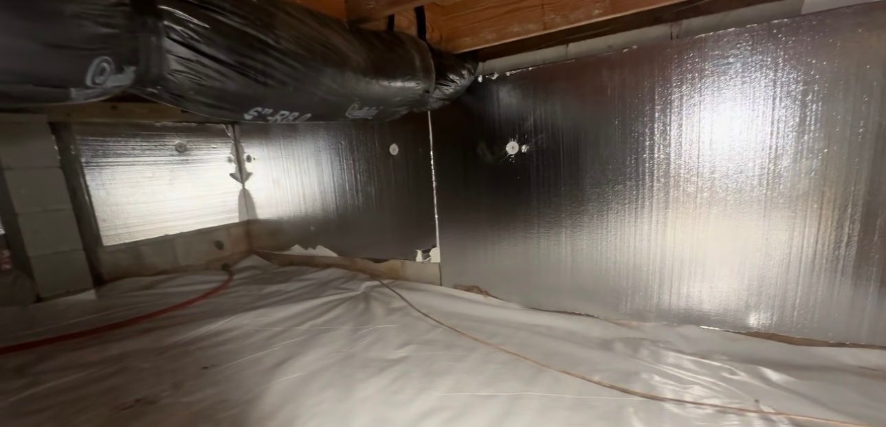 A basement with a lot of insulation on the walls and floor.