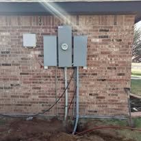 A brick building with a electrical box on the side of it.