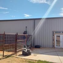 A tire is sitting on the sidewalk in front of a building.