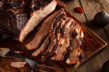 sliced brisket on wooden cutting board