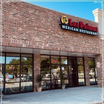 Exterior of Las Palmas Mexican Restaurant, brick facade, large windows, red signage with palm tree logo.