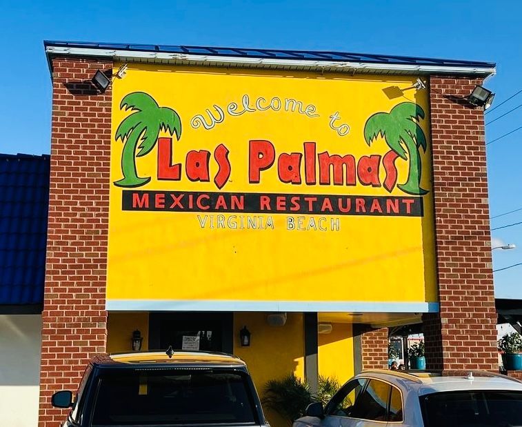 Las Palmas Mexican Restaurant exterior with yellow wall, red text, palm tree logo, and brick accents.