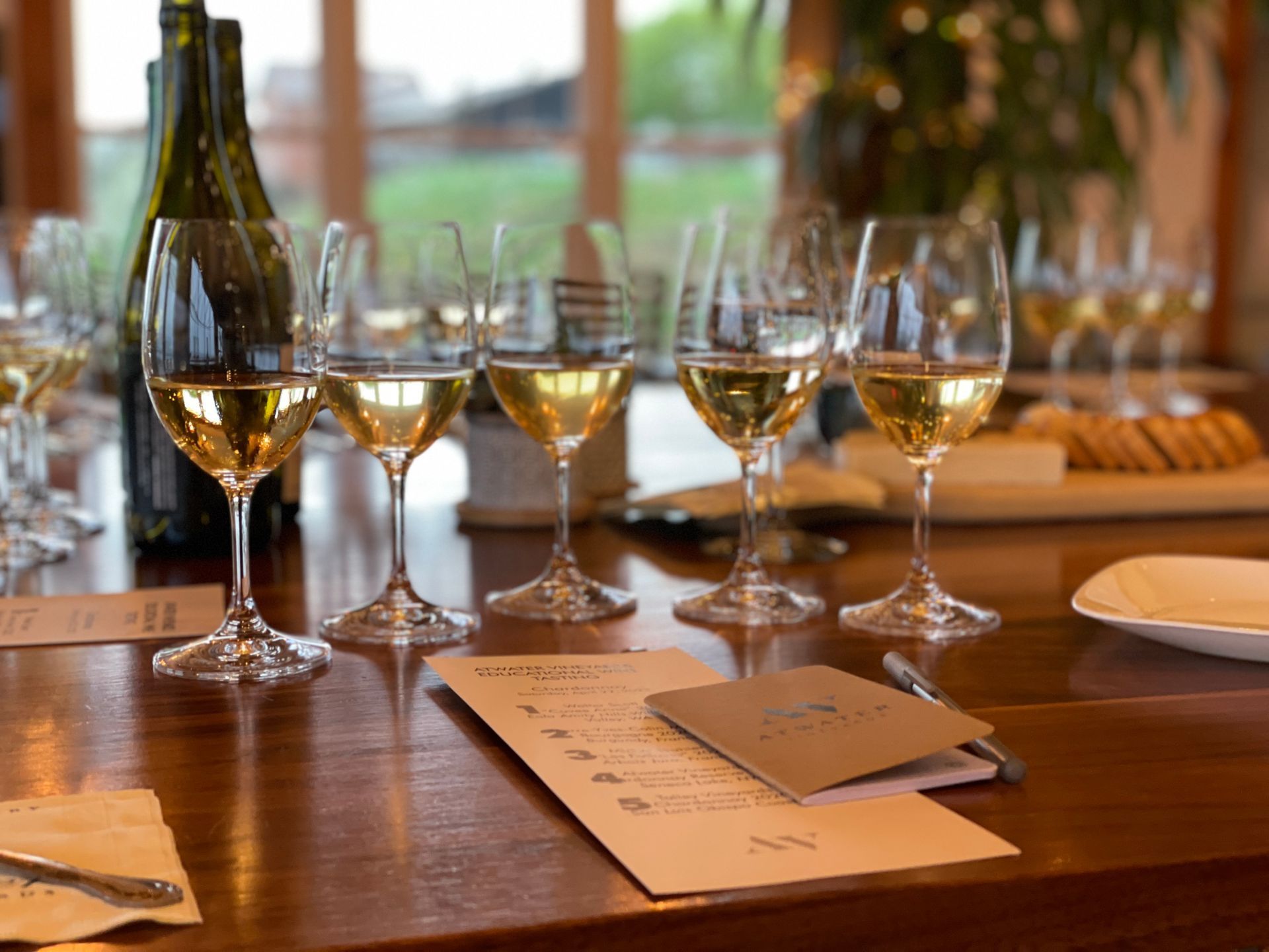 A person is pouring wine into a glass from a barrel