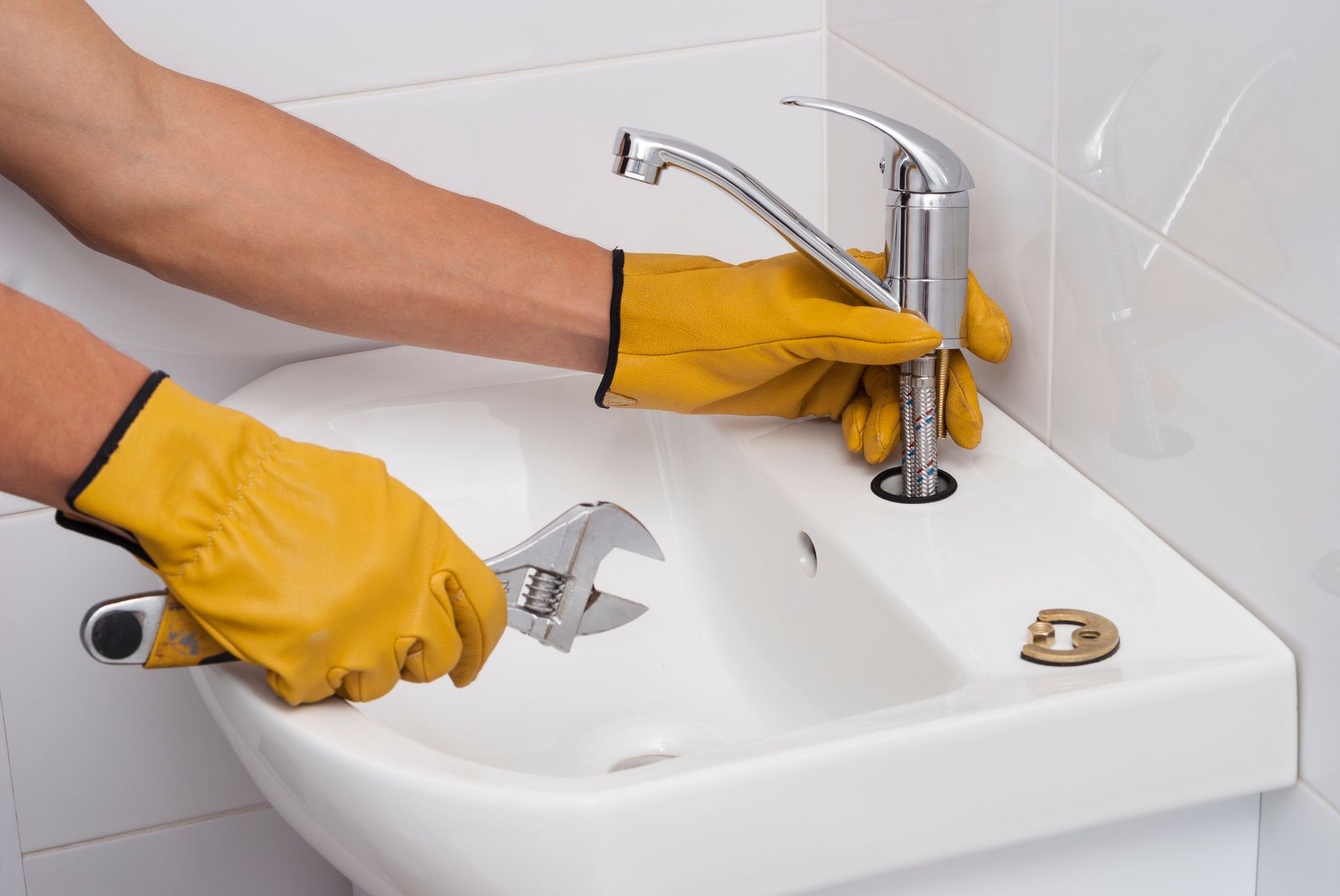 Person fixing a faucet.