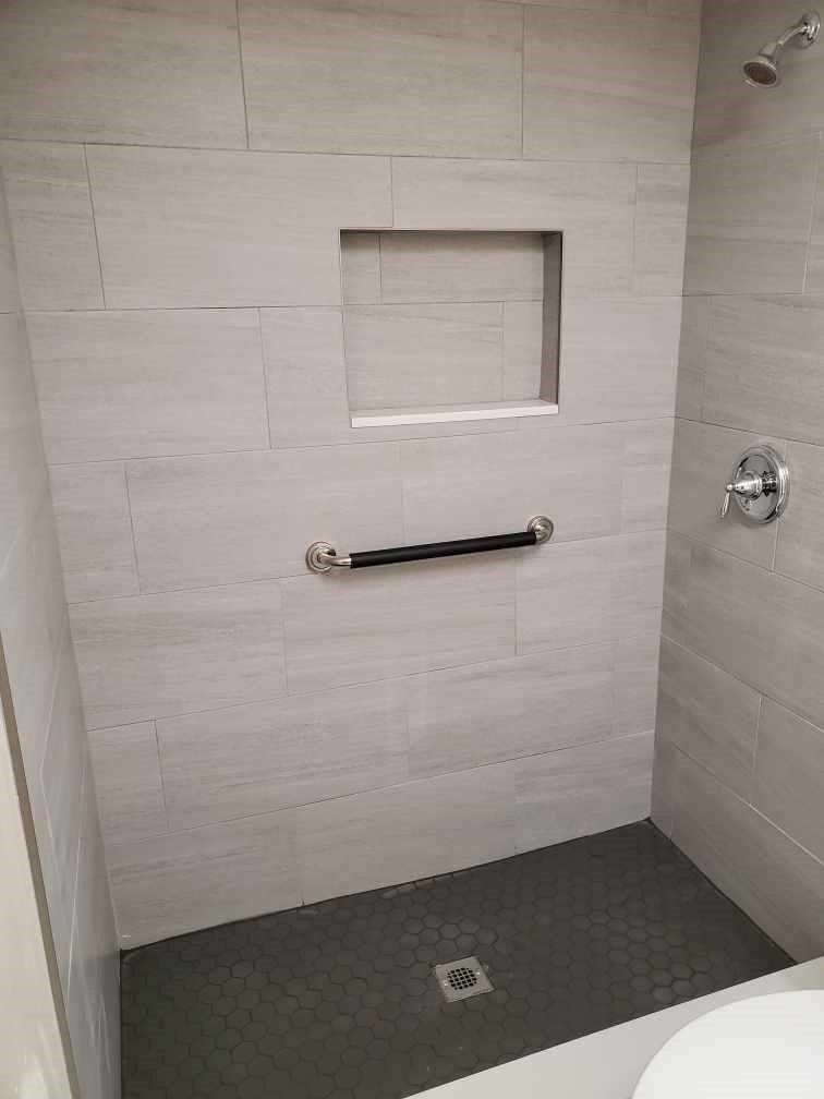 A bathroom with a walk in shower and a toilet.