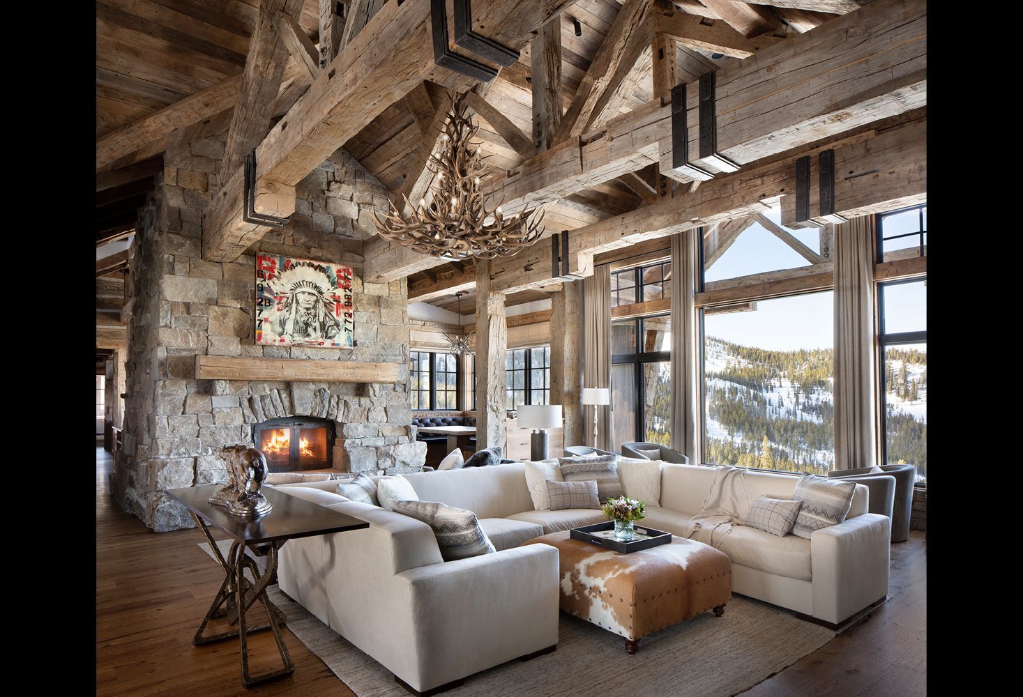 A living room with a large sectional couch and a fireplace