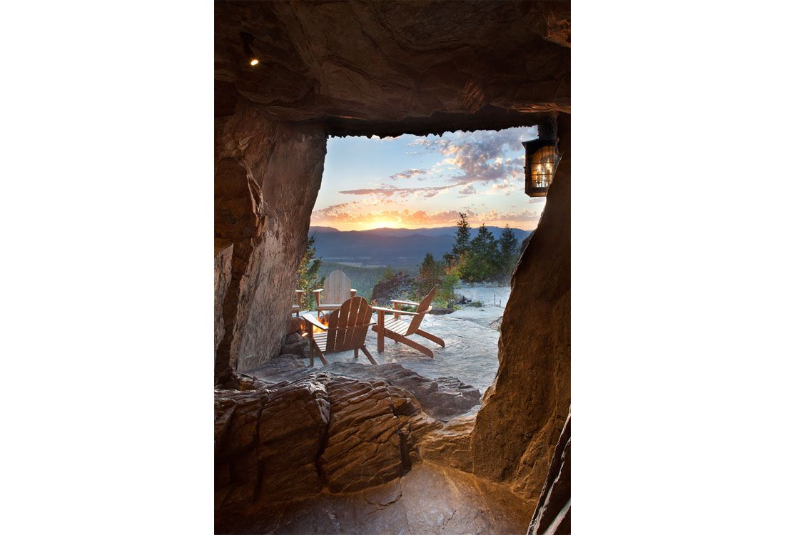 A view of a sunset through a window in a cave.