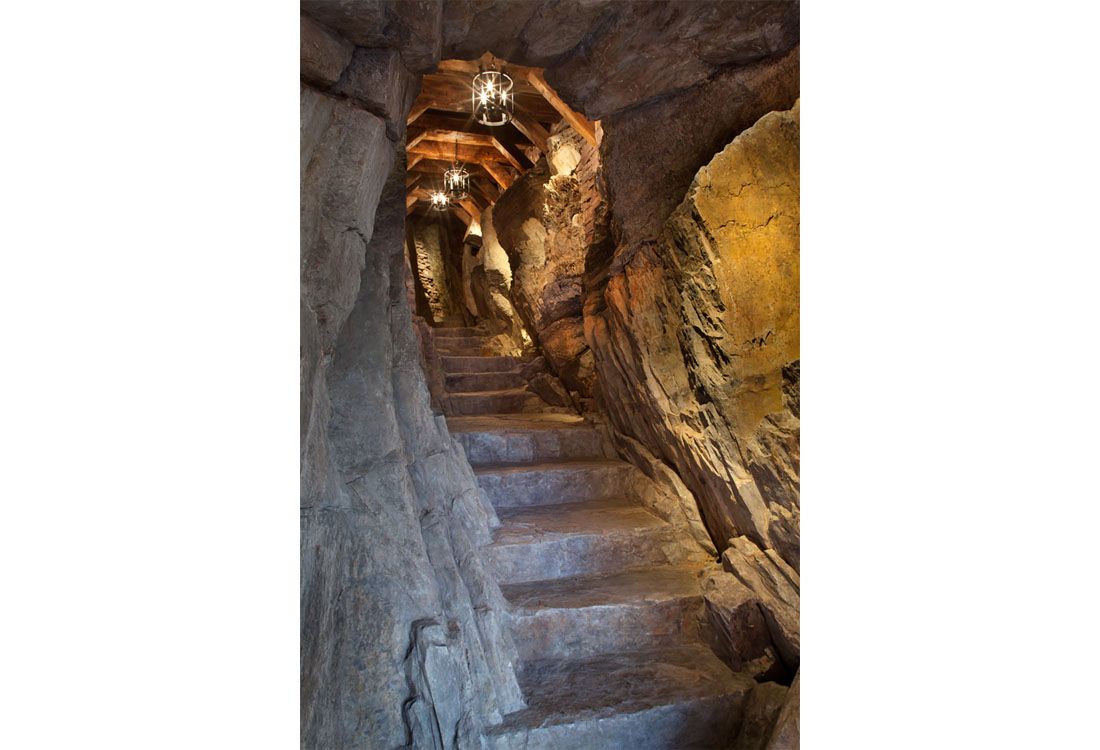 A set of stairs leading up to a cave.