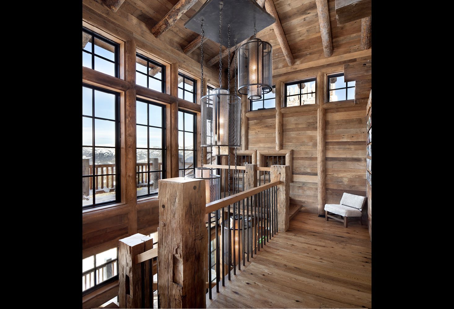A wooden house with a staircase and lots of windows
