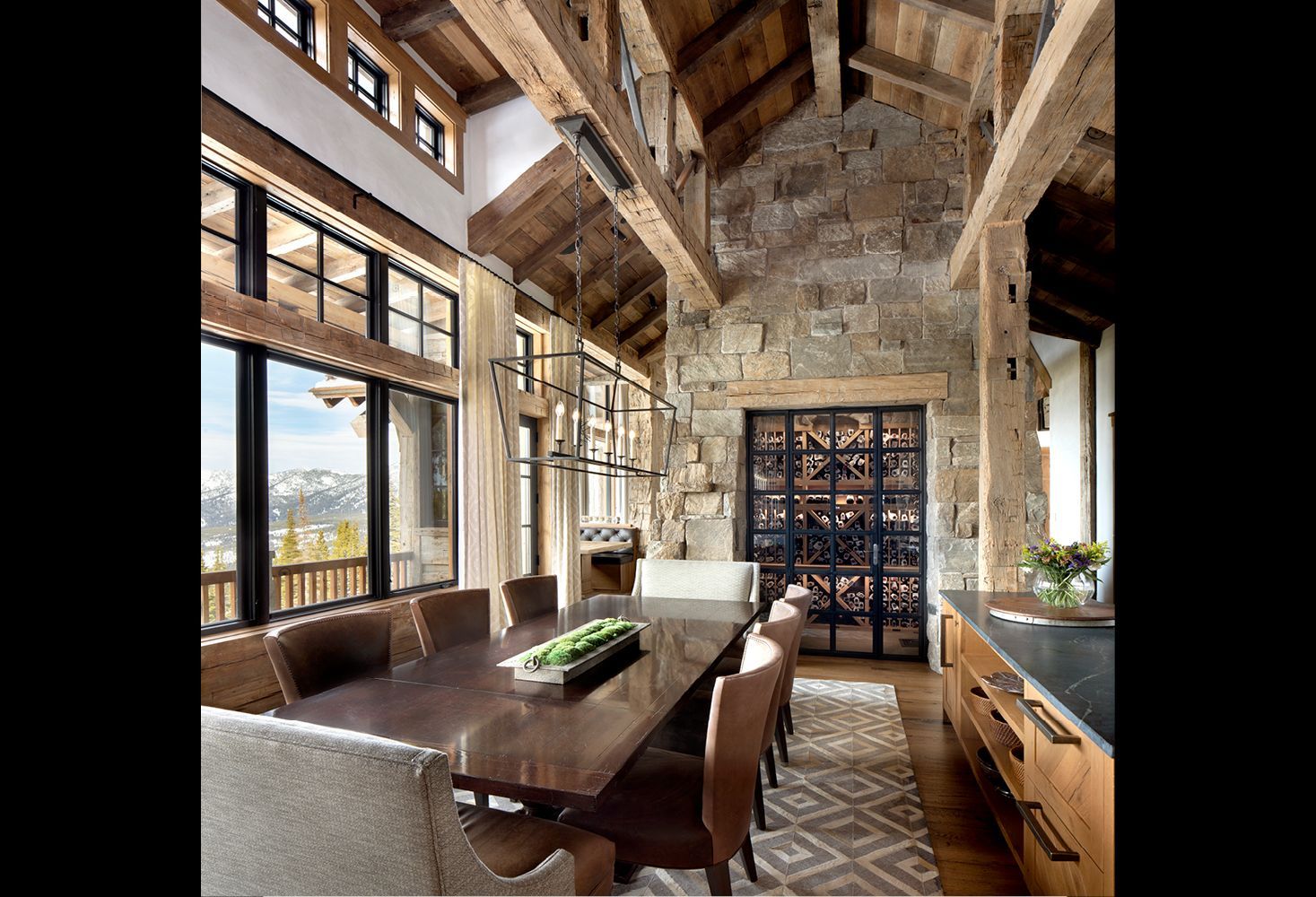 A dining room with a long wooden table and chairs