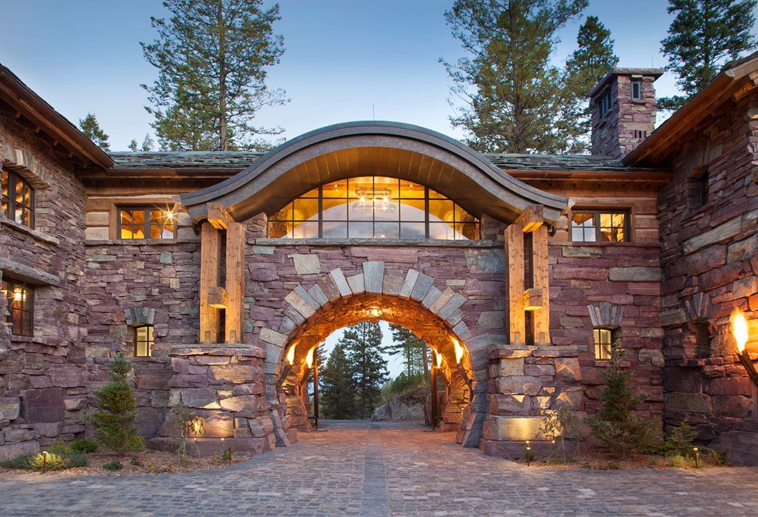 A large stone building with a large archway leading to it.