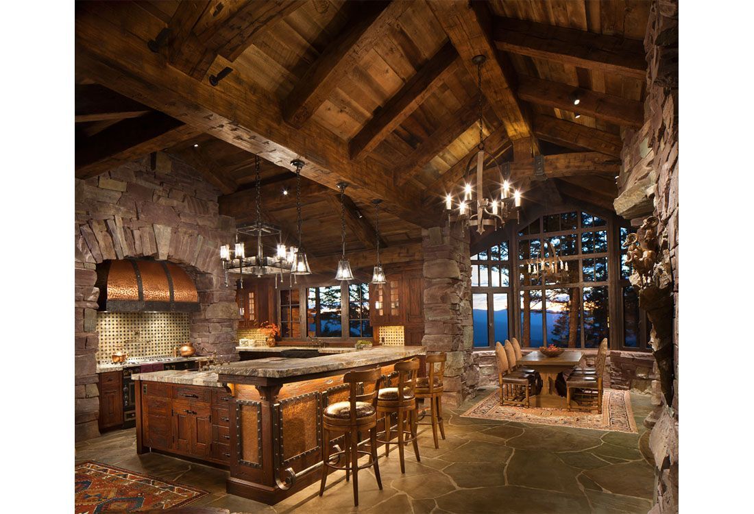 A kitchen with a large island and a dining room in the background.