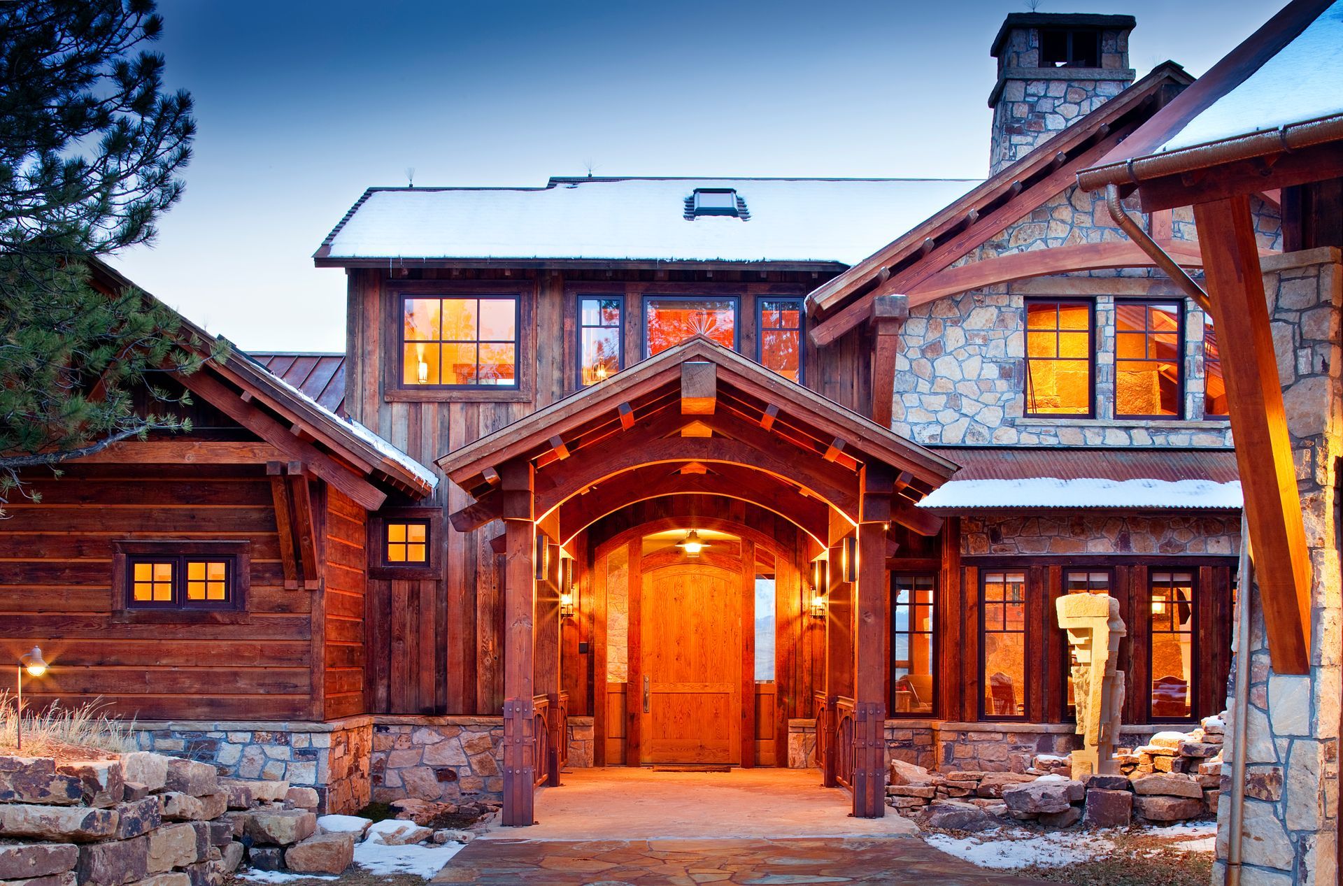 A large wooden and stone house with a large wooden door