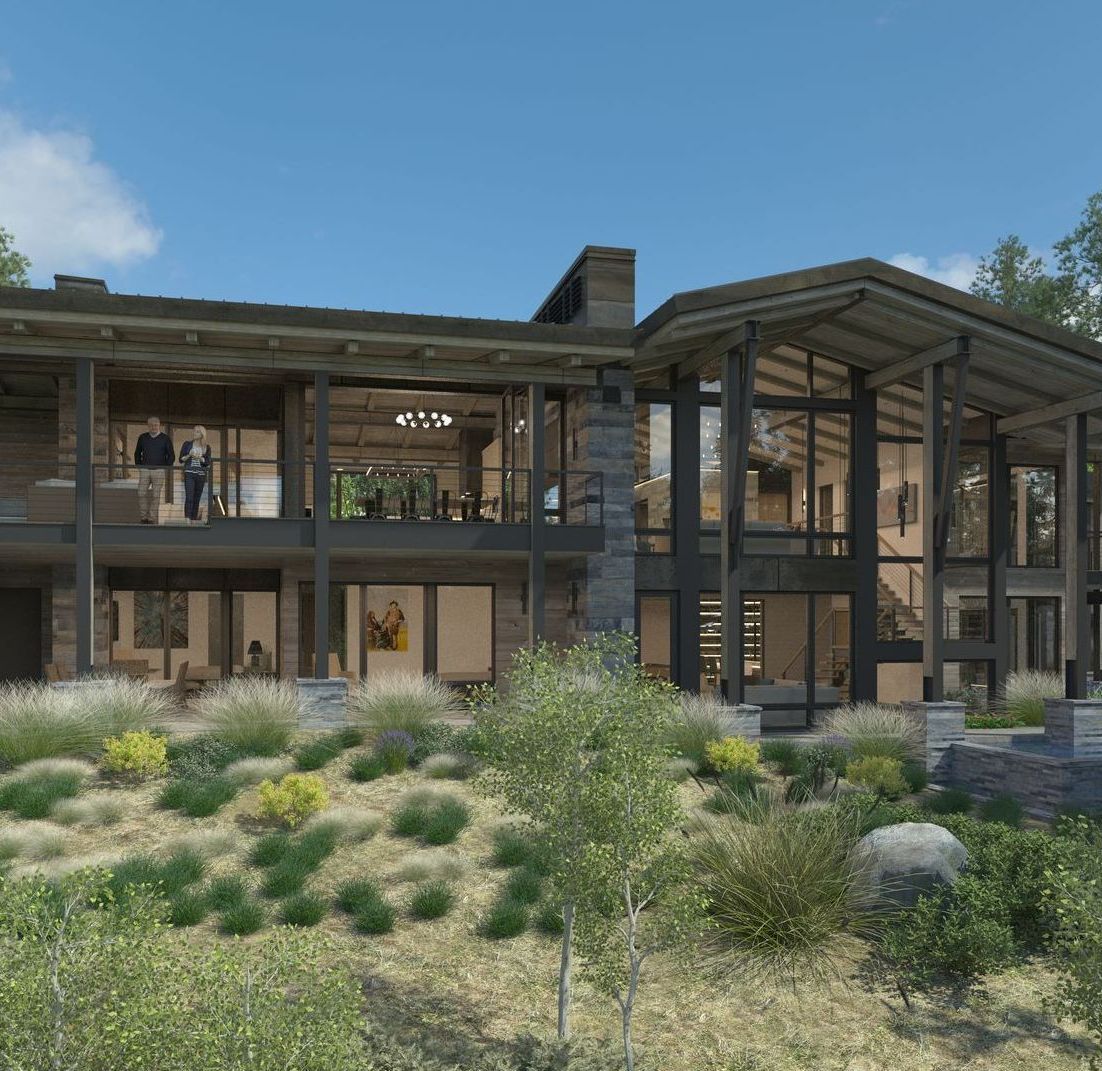 A large house is sitting on top of a hill surrounded by trees.