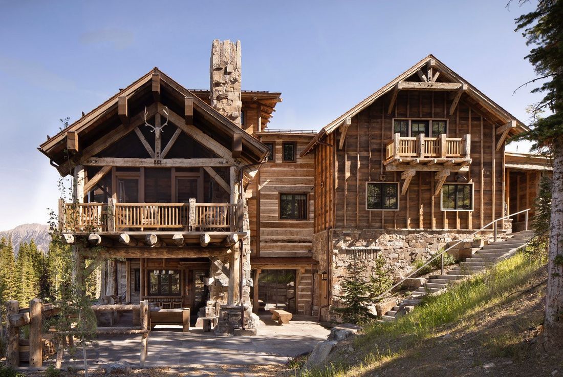 A large log cabin sitting on top of a hill