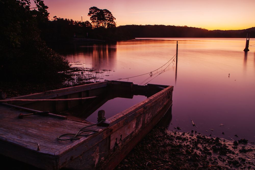 A Dock In The Middle Of A Lake At Sunset — Eurobodalla Windscreens in Moruya, NSW