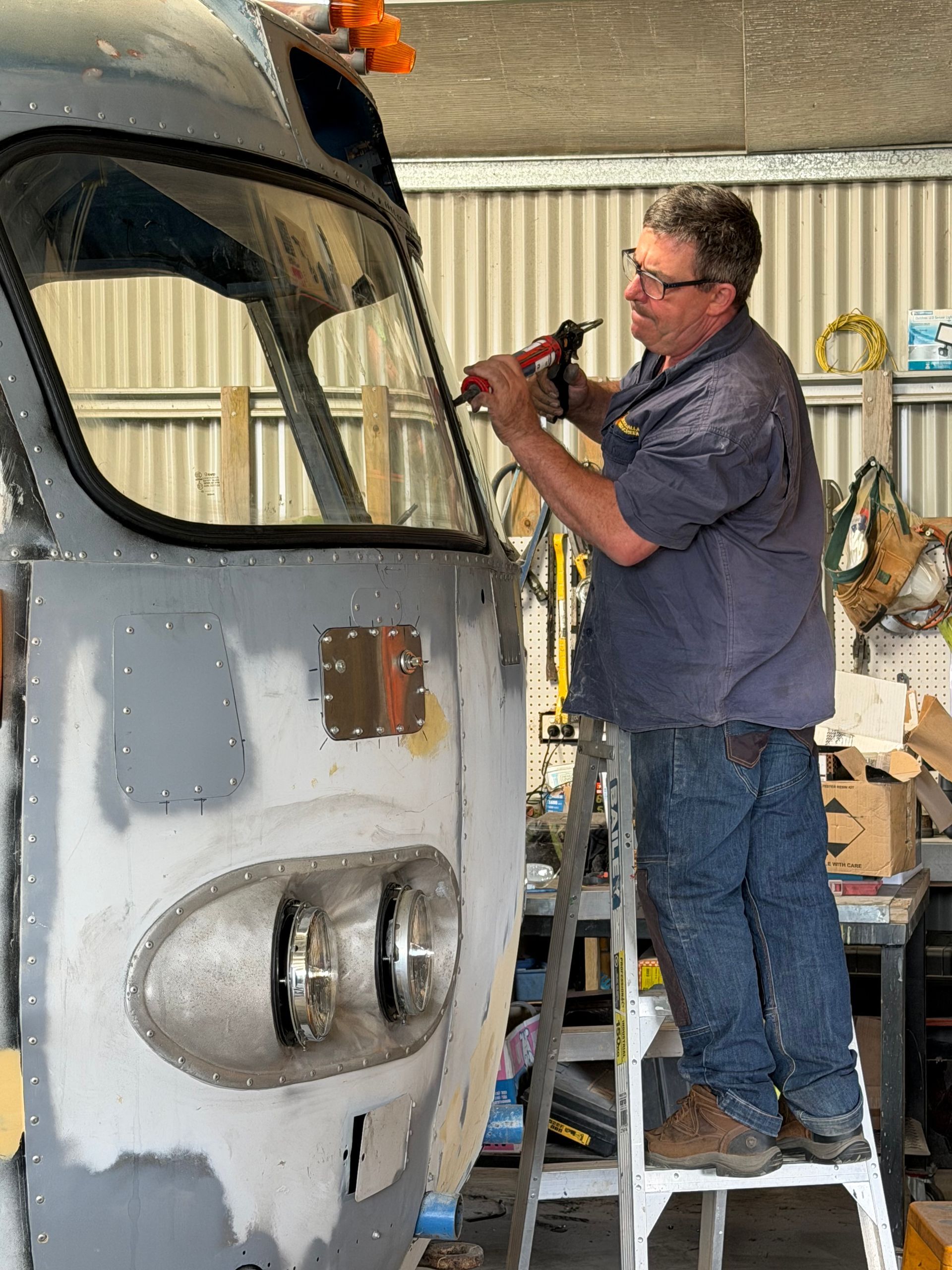 Man on Stepladder Fixing A Windscreen - Eurobodalla Windscreens in Moruya, NSW
