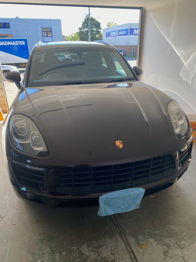A Man is Installing a Windshield on a car — Eurobodalla Windscreens in Moruya, NSW