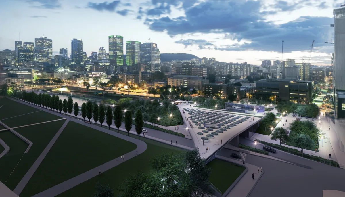 Une vue aérienne d'une ville la nuit avec un pont au premier plan