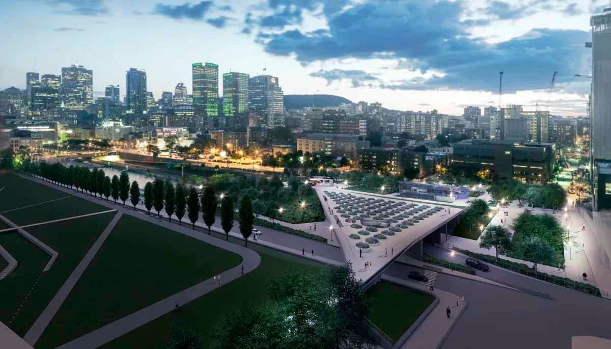 Une vue aérienne d'une ville la nuit avec un pont au premier plan