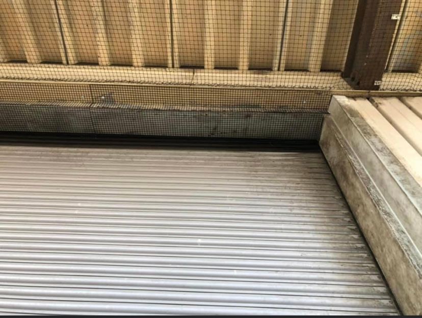 A close up of a metal shutter on a building.