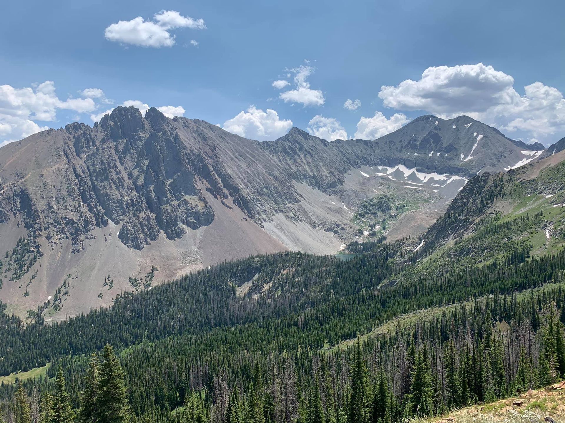 A mountain range with trees and mountains in the background