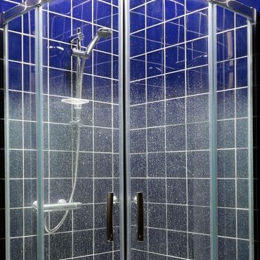 shower cubicle with limescale on glass