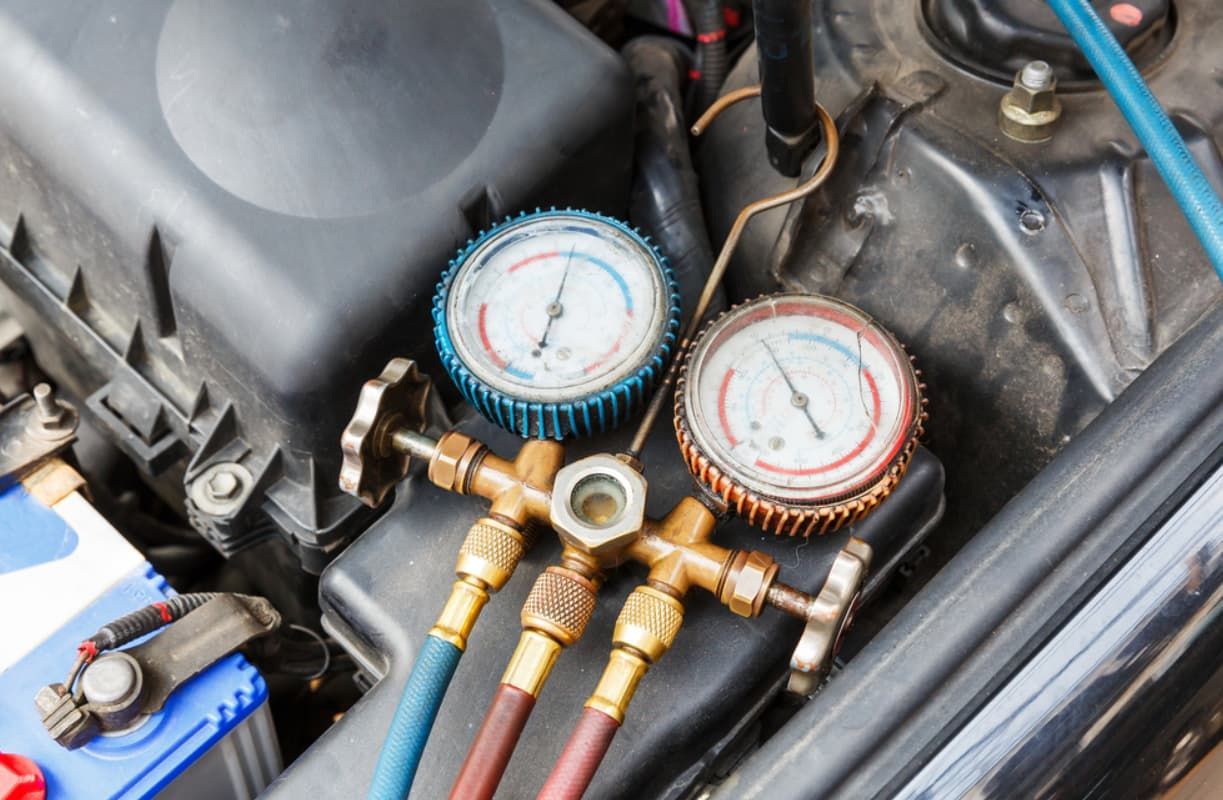 A Close Up Of A Car Engine With Gauges On It — Bartons Auto Air Conditioning In Tolga, QLD