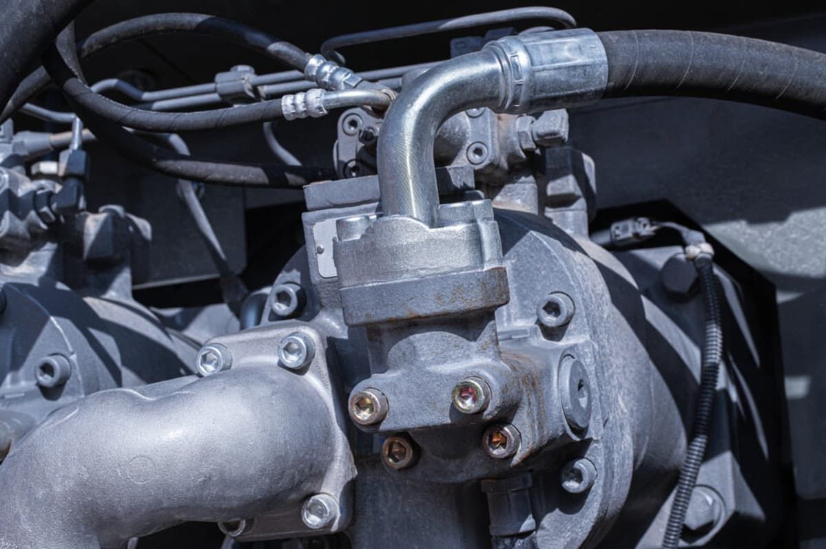 A Close Up Of A Hydraulic Pump With Hose Attached To It — Bartons Auto Air Conditioning In Tolga, QLD