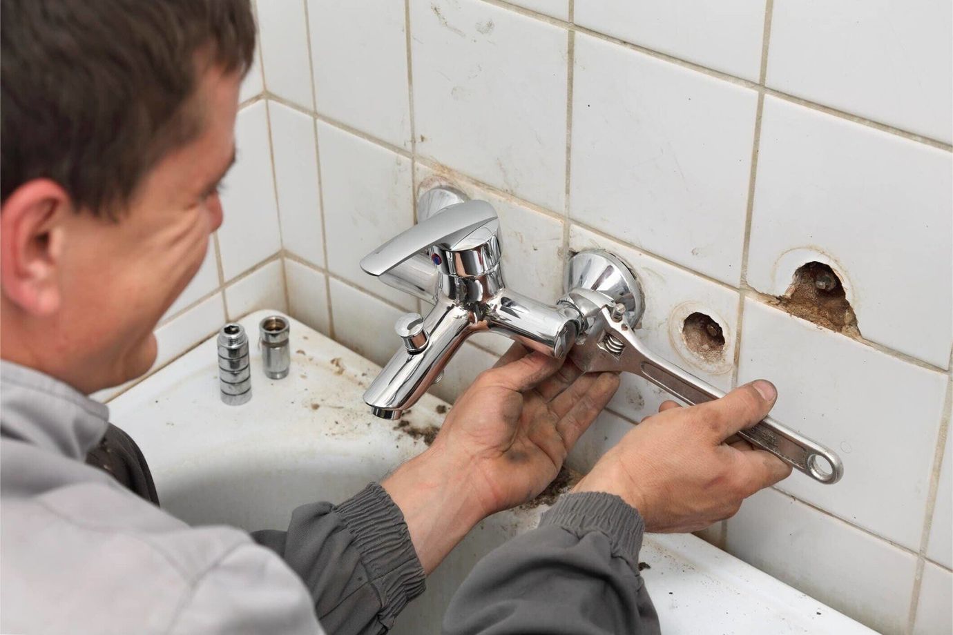 Plumber replacing bathroom sink — Plumbing services in Spanaway, WA