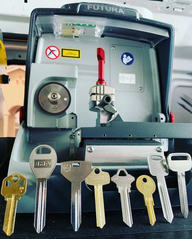 Locks Keys and More | A bunch of keys are sitting in front of a futura machine