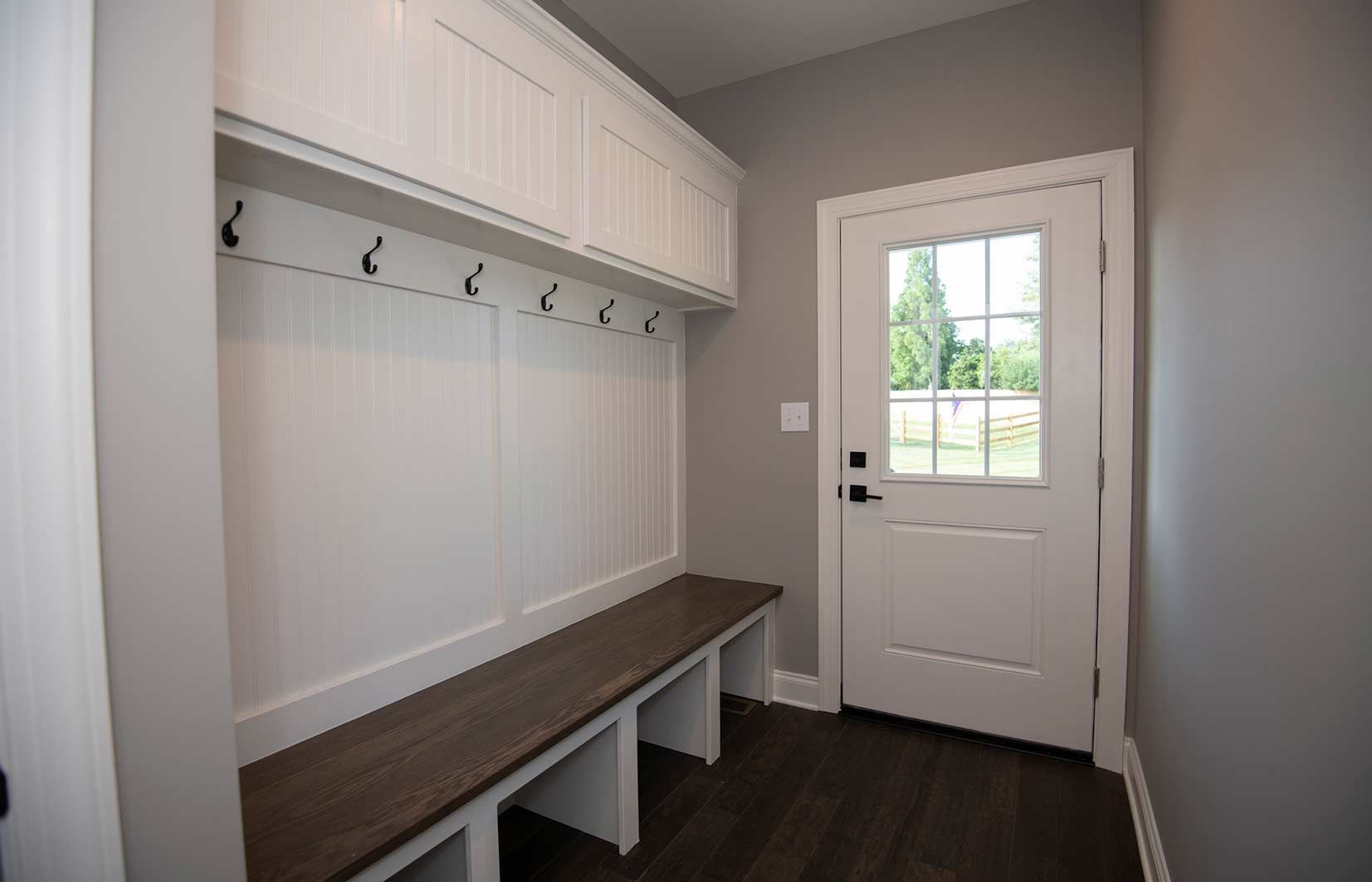 There is a bench in the mud room next to the door.