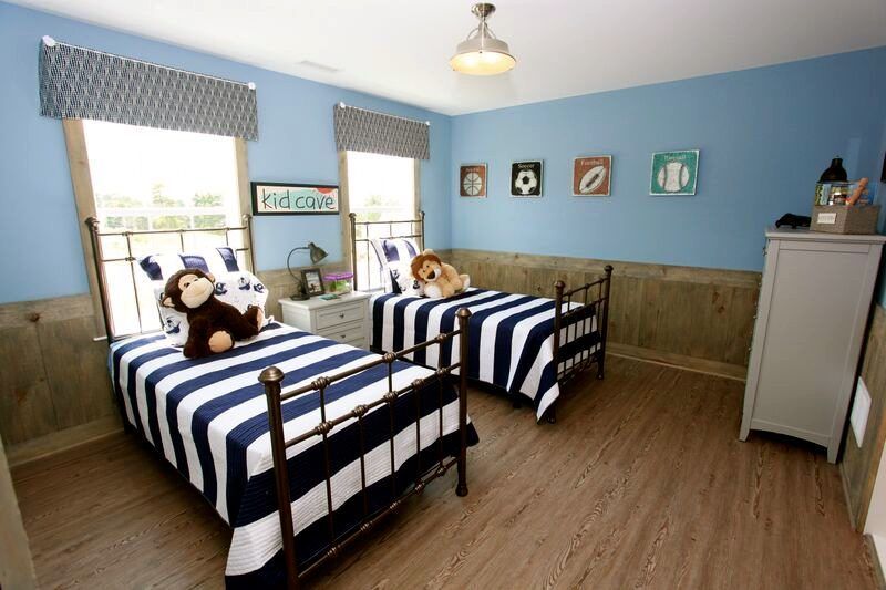 A bedroom with two beds and a monkey on the bed