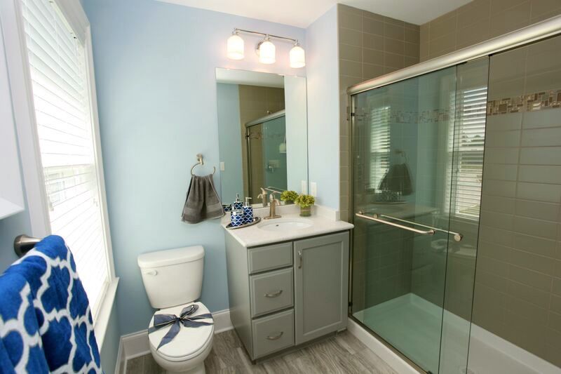 A bathroom with a toilet , sink , and shower.