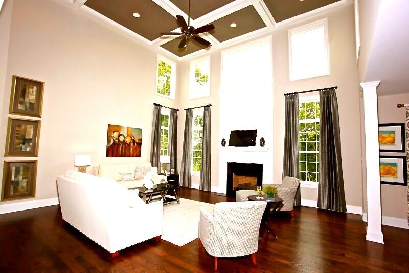 A living room with a fireplace and a ceiling fan