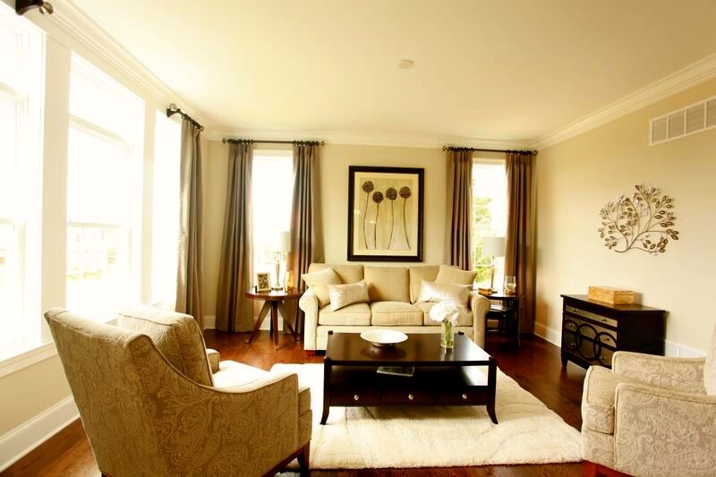 A living room with a couch and two chairs