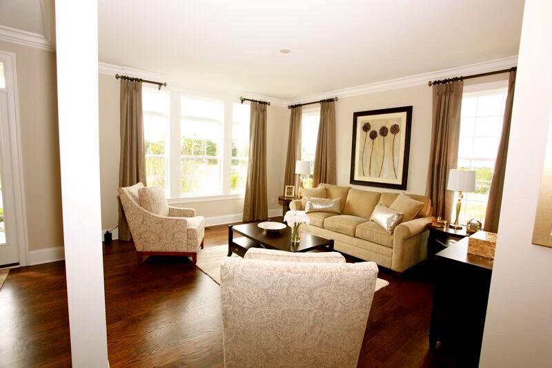 A living room with a couch and two chairs