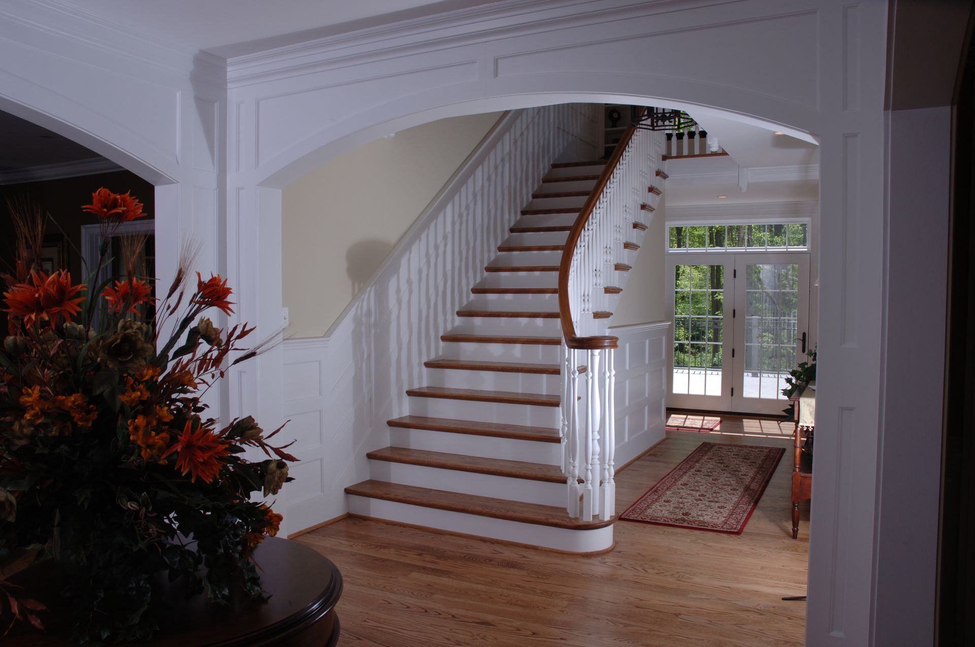 A white staircase with wooden steps in a house